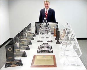 Sheehan Vanland posing with multiple Awards