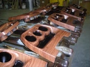 Custom woodgrain interior trims being prepared in assembly line