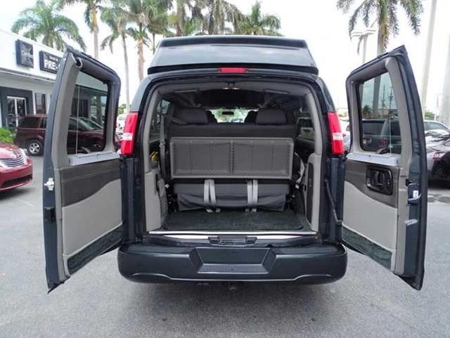 Rear view of an open van with folded back seats.